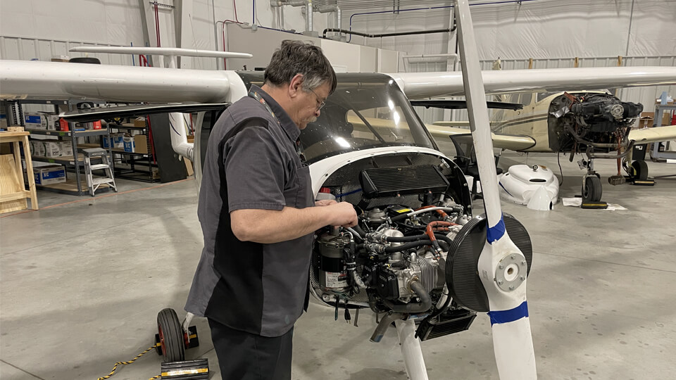 Aircraft Mechanic Working on a Flight School Airplane