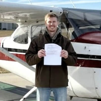 Flight Training Student Next to Airplane