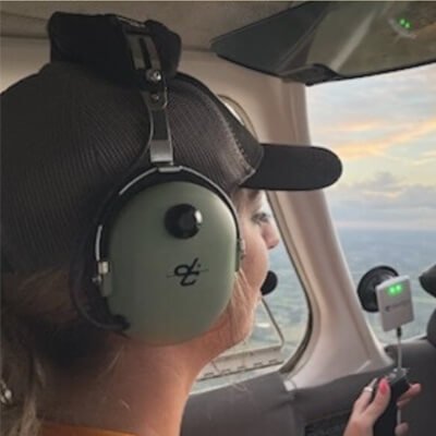 Flight Training Student Next to Airplane